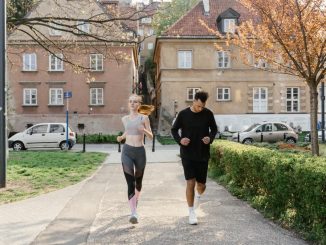 A couple jogging together in an urban park, enjoying outdoor exercise.