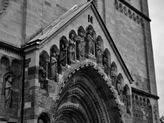Vintage-style photograph capturing the intricate details of Ják Church's façade in Hungary.